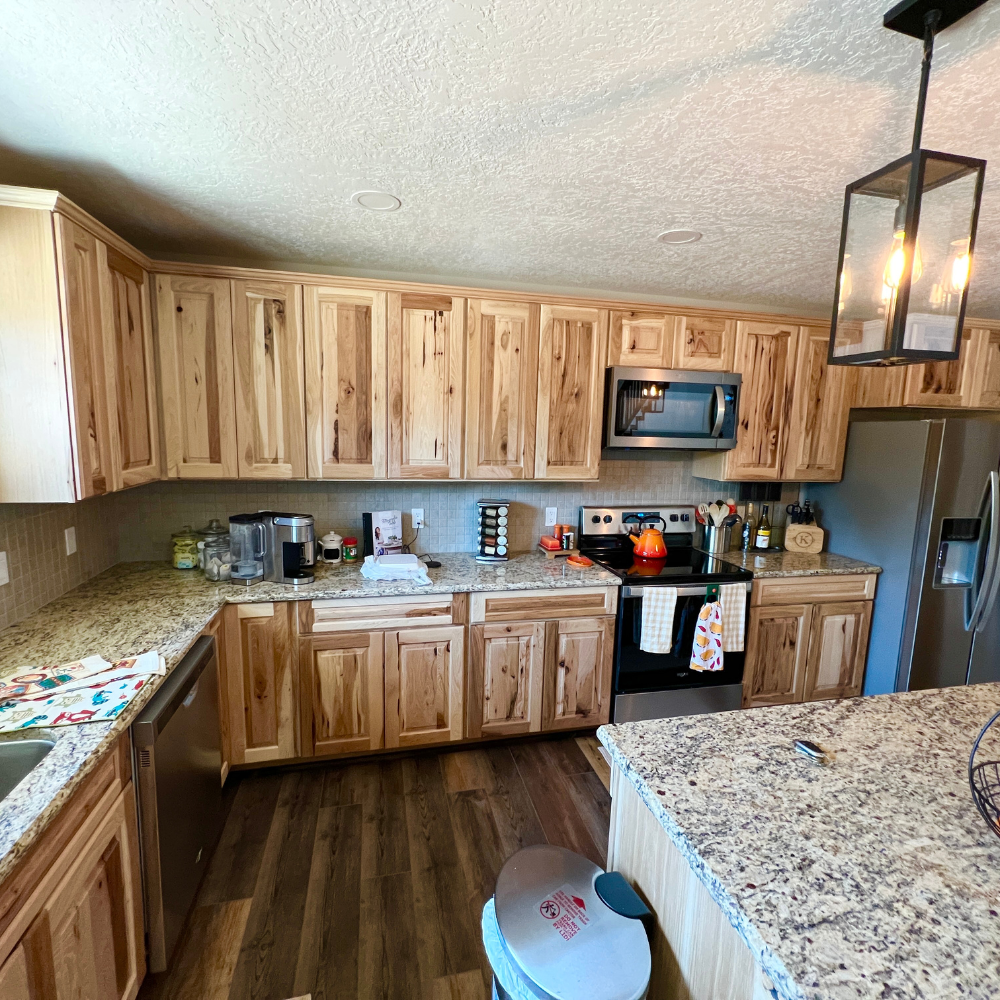 Light wood kitchen cabinets with granite counters. 